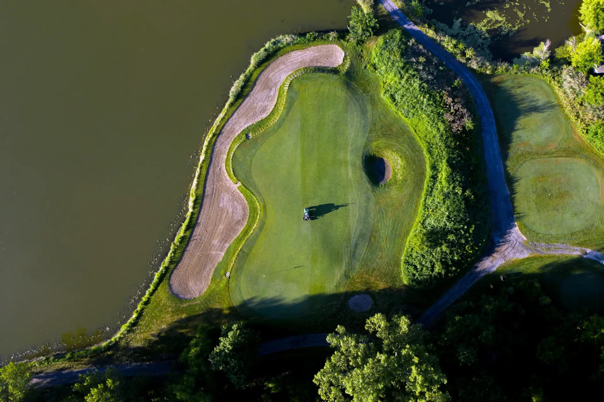 Golfer finishing a round on the green